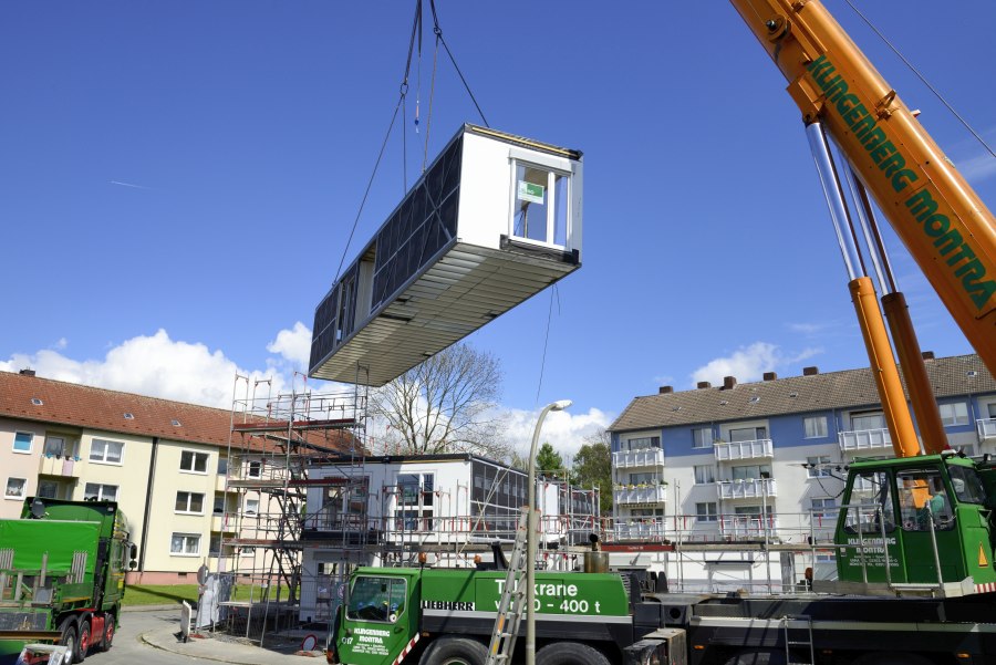Schwebendes Modul am Kran über der Baustelle